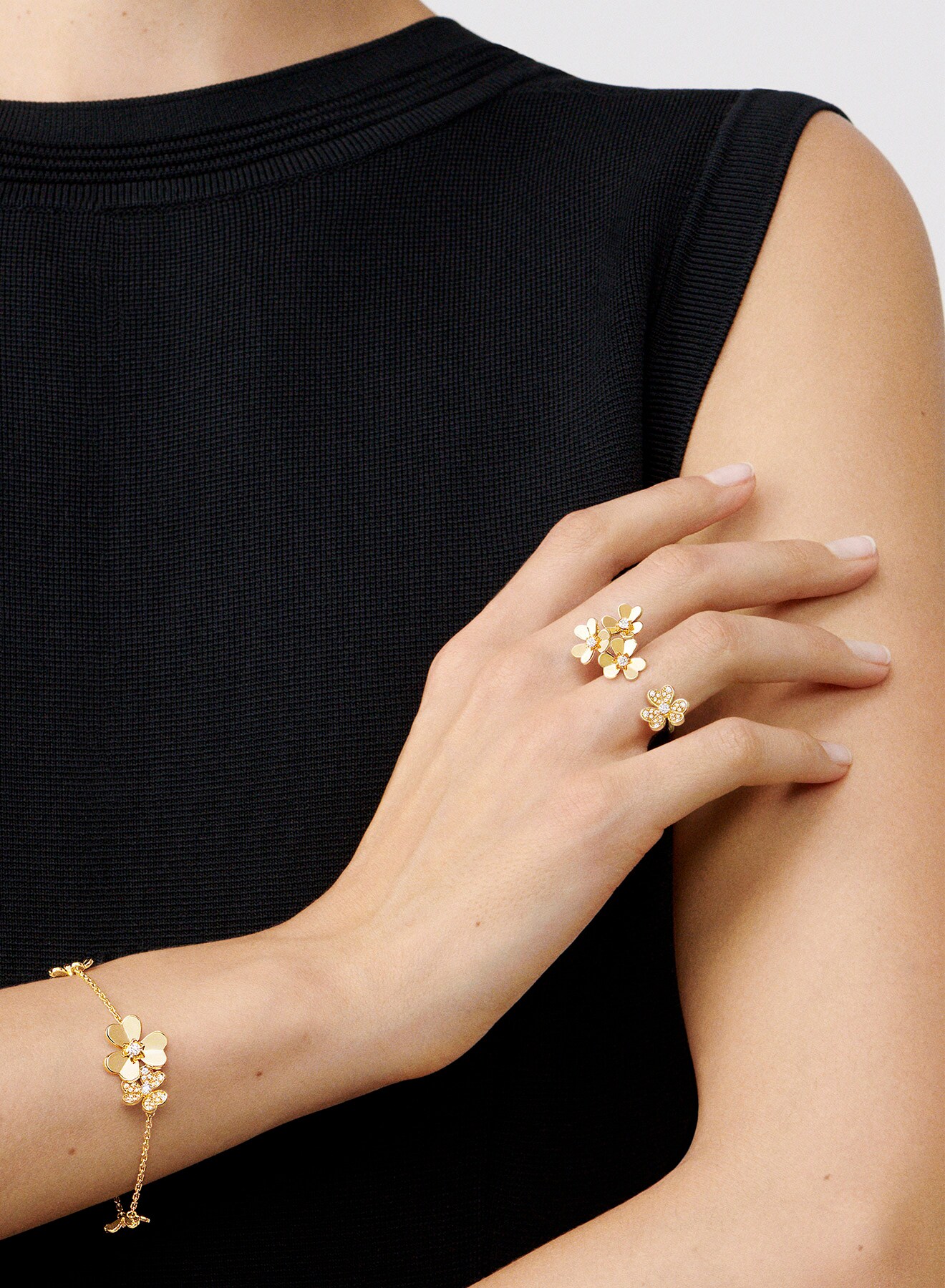 Between the Finger Rings™ collection, ring and bracelet, yellow gold, hand resting on arm, Van Cleef & Arpels