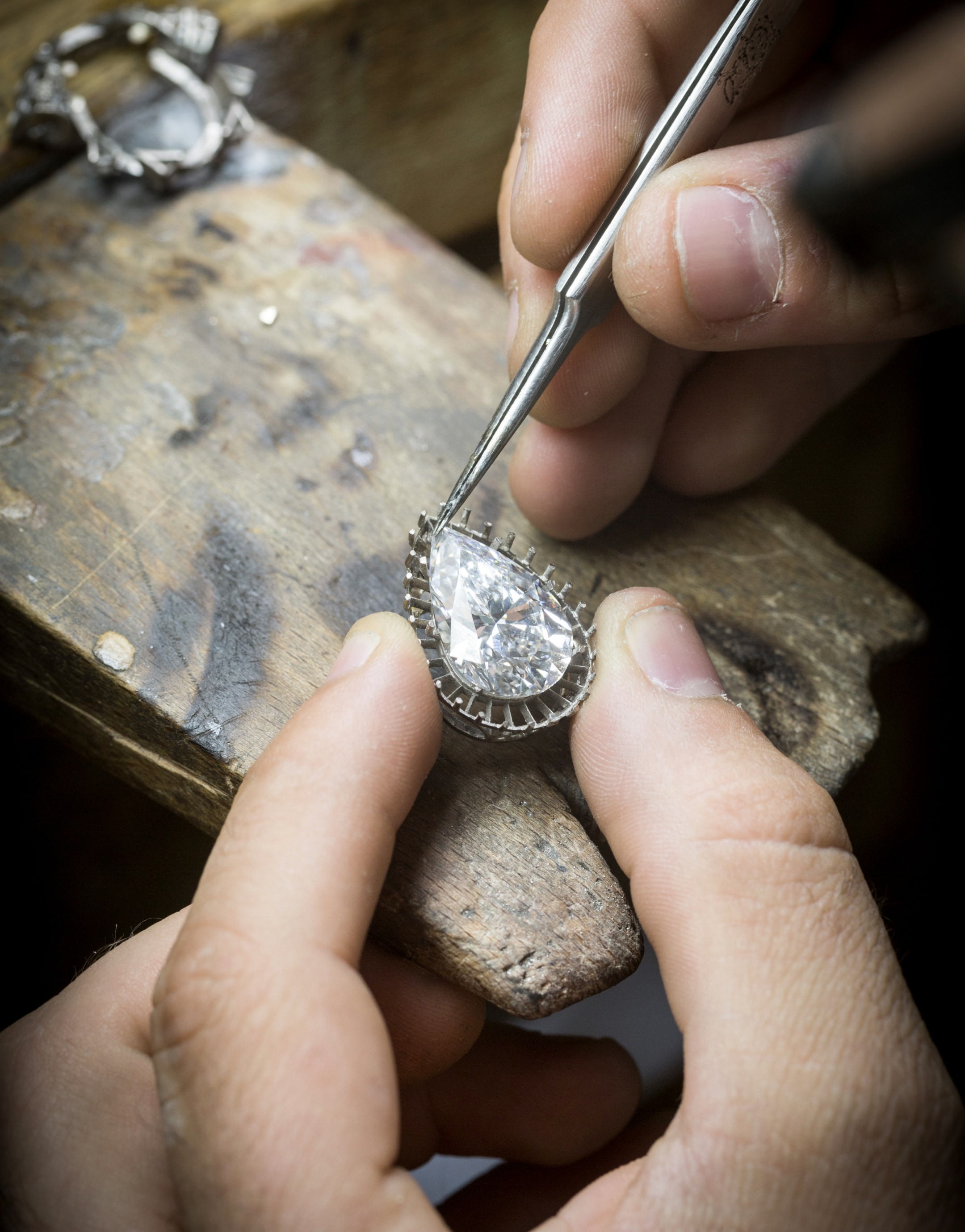 Checking the adjustment of the center diamond on the motif, Bleu Absolu necklace.