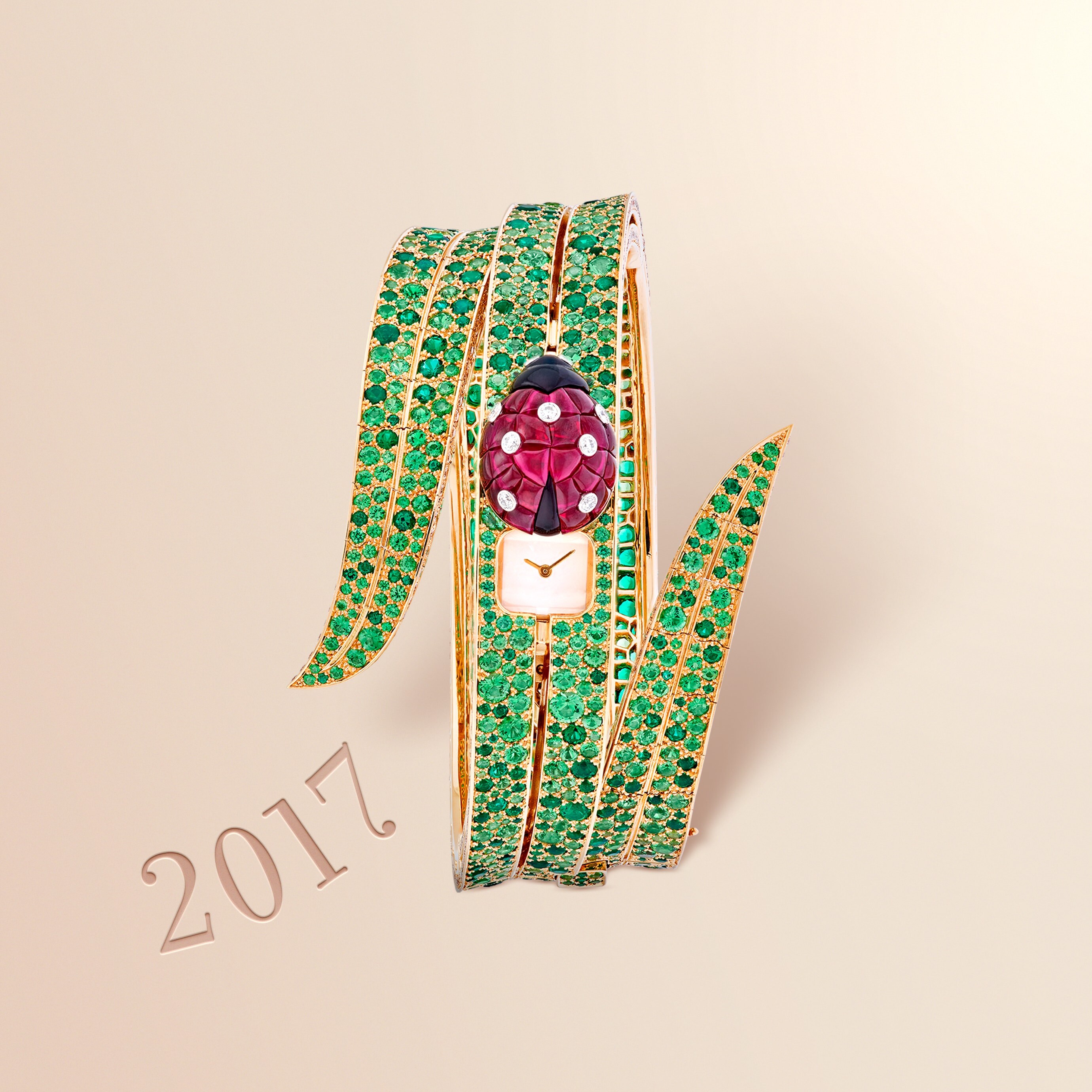 Secret de Coccinelle watch, 2017. 18K yellow gold case, Traditional Mystery Set buff-topped rubies, round diamonds, onyx, 18K yellow gold bracelet, round emeralds, round tsavorite garnets, 18K yellow gold clasp, diamonds, unique piece. Van Cleef & Arpels.