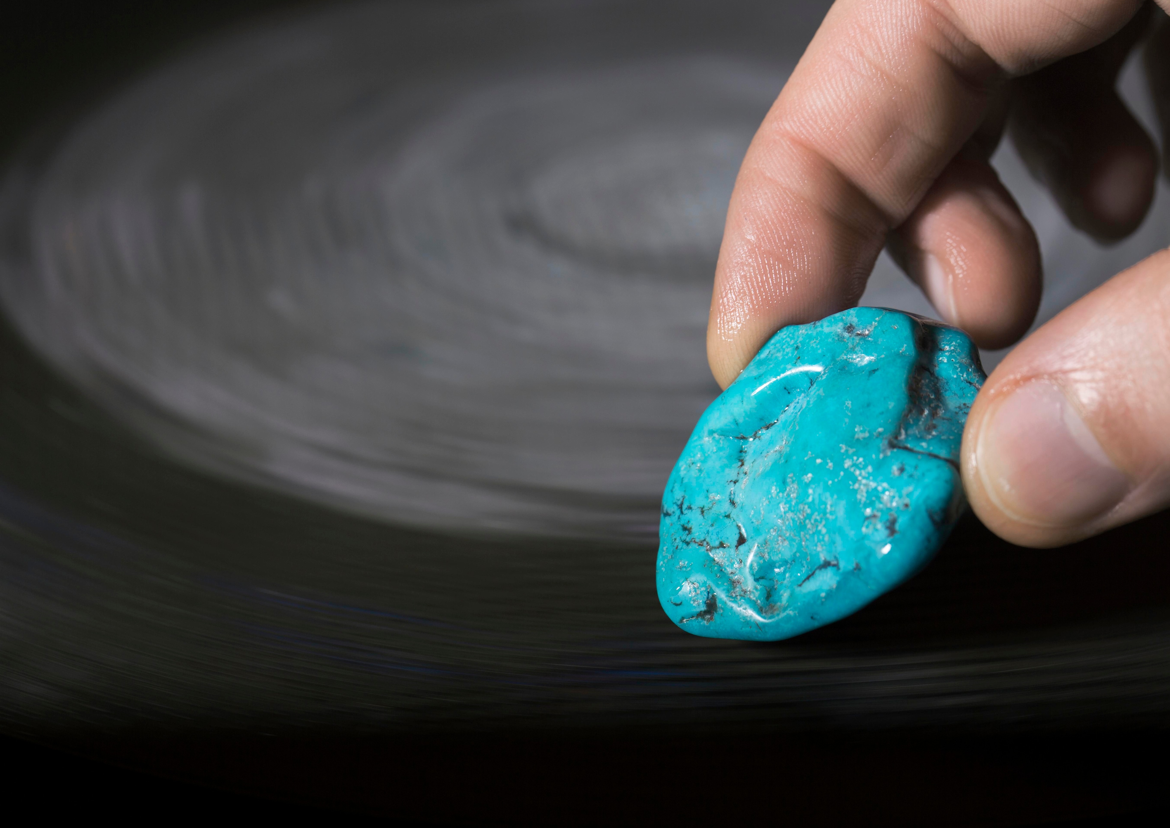 Sculpting the rough turquoise stone. Van Cleef & Arpels.