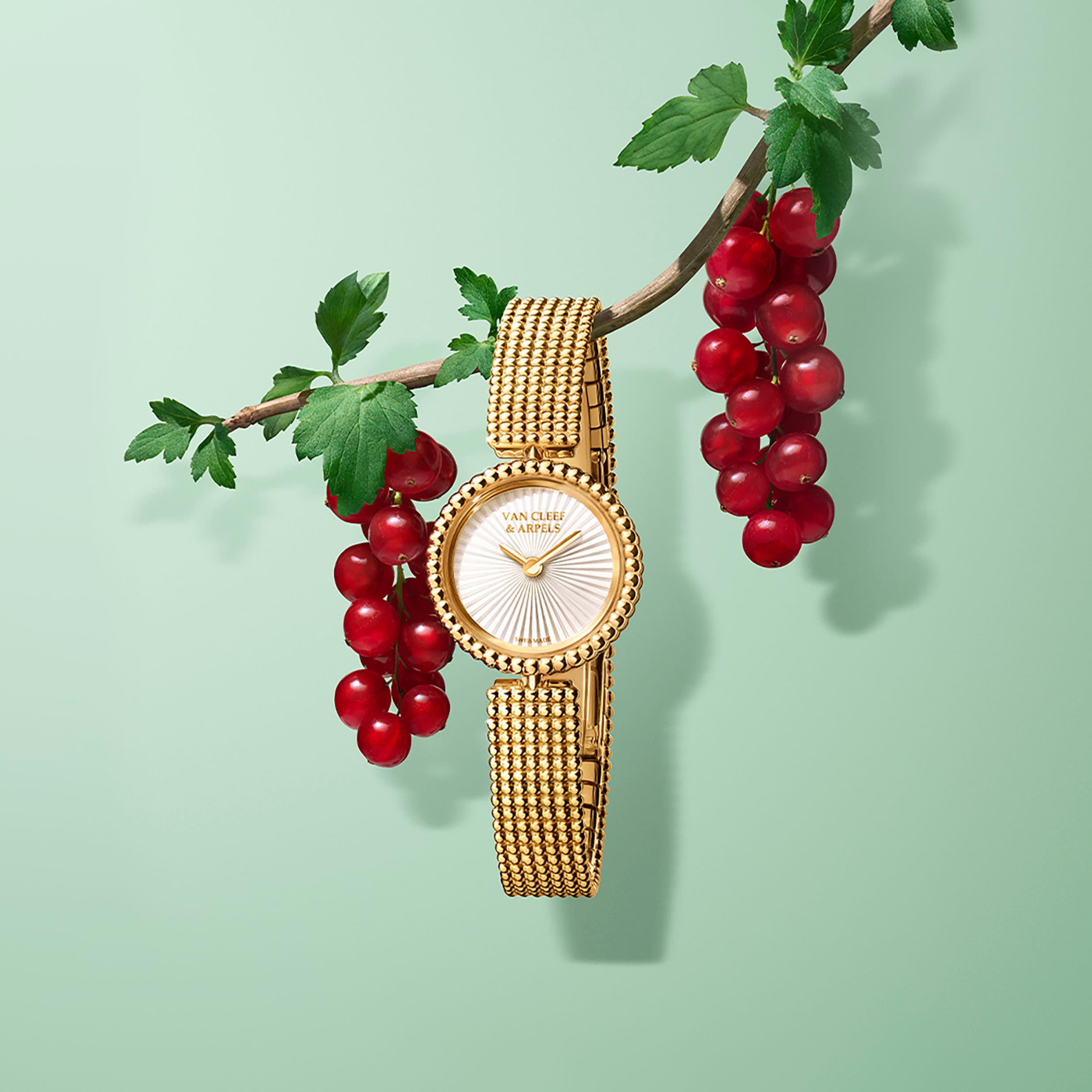 Watch, 23 mm, 18K yellow gold, guilloché white mother-of-pearl, Swiss quartz movement. Perlée collection, Van Cleef & Arpels.