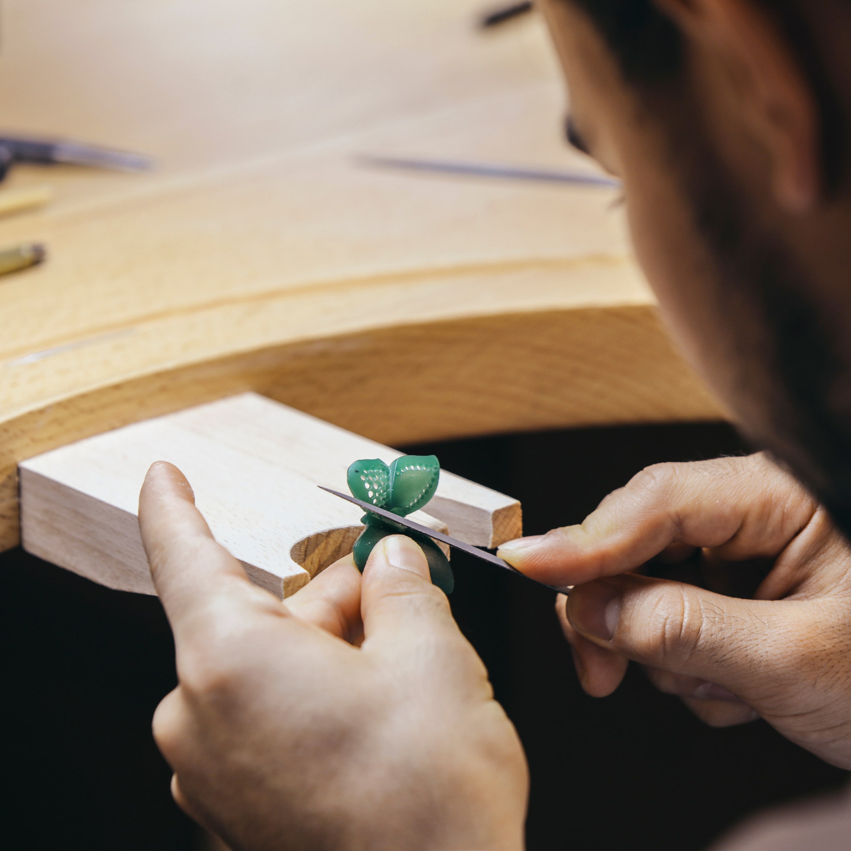 Adjusting the green wax. Van Cleef & Arpels.