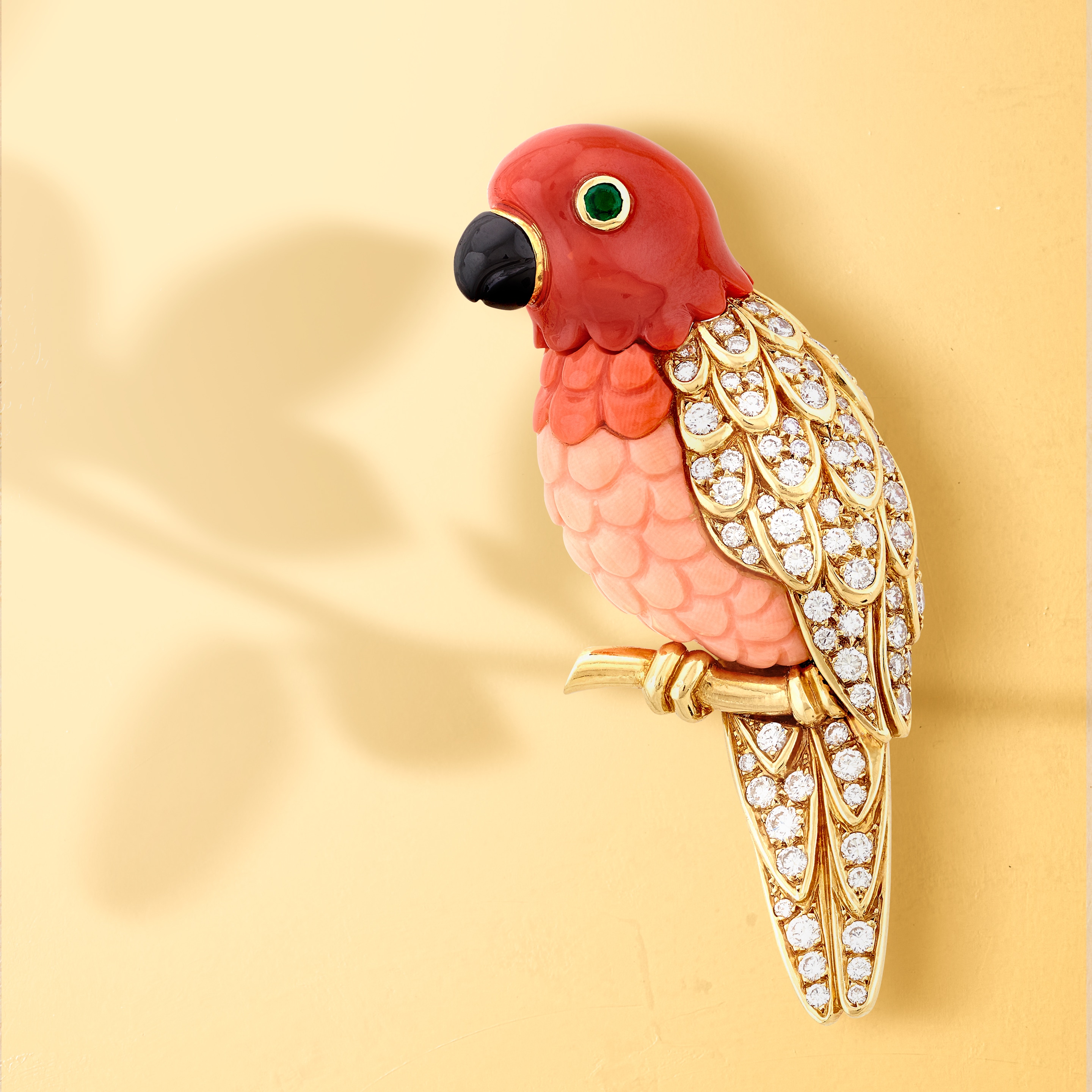 Perroquet clip, 1988. Yellow gold, white gold, emerald, coral, onyx, diamonds. Heritage collection. Van Cleef & Arpels
