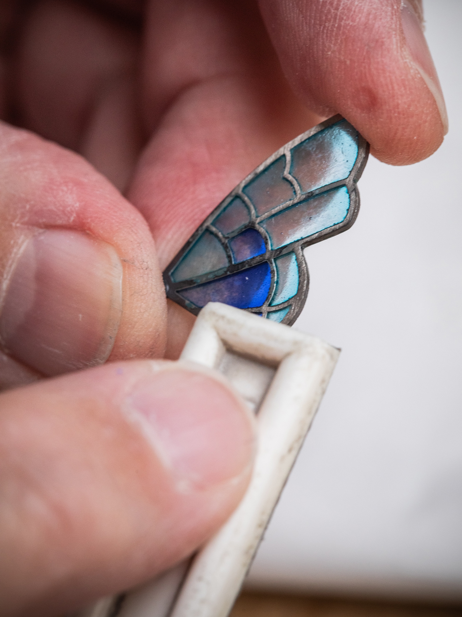 Lapidating the enamel with a diamond file to even out the surface. Bouton d'Or automaton, Extraordinary Objects collection, Van Cleef & Arpels.