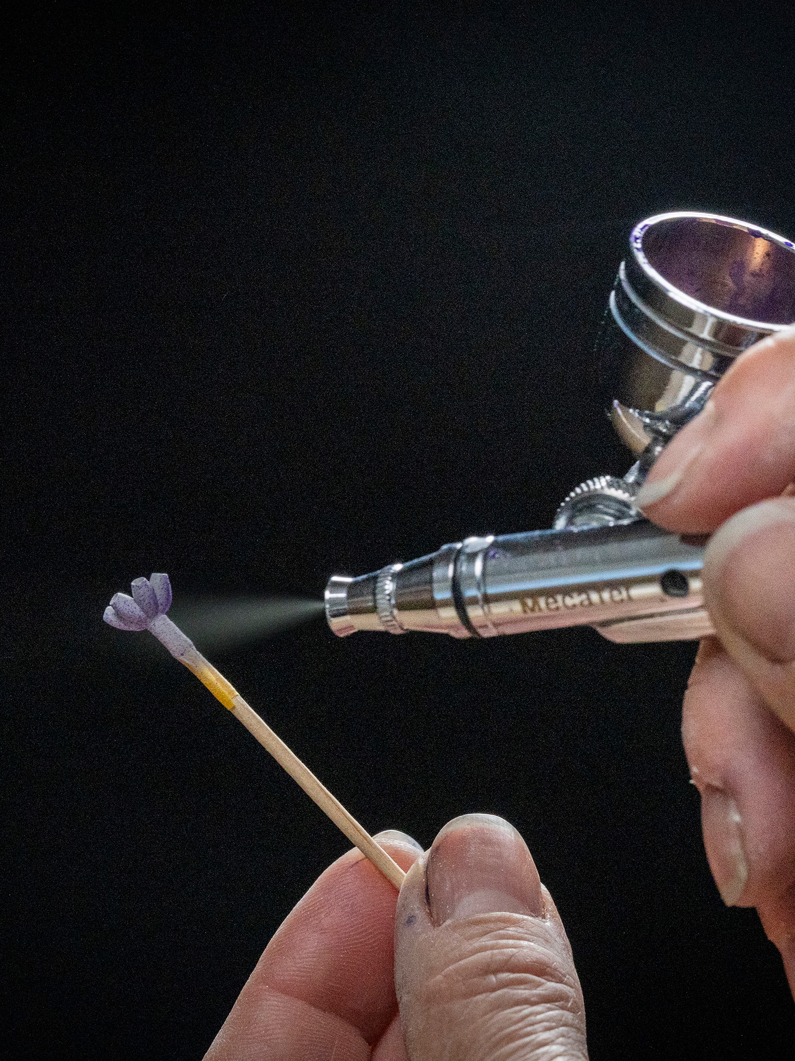 Lacquer airbrush application on the rose gold corolla, Van Cleef & Arpels.