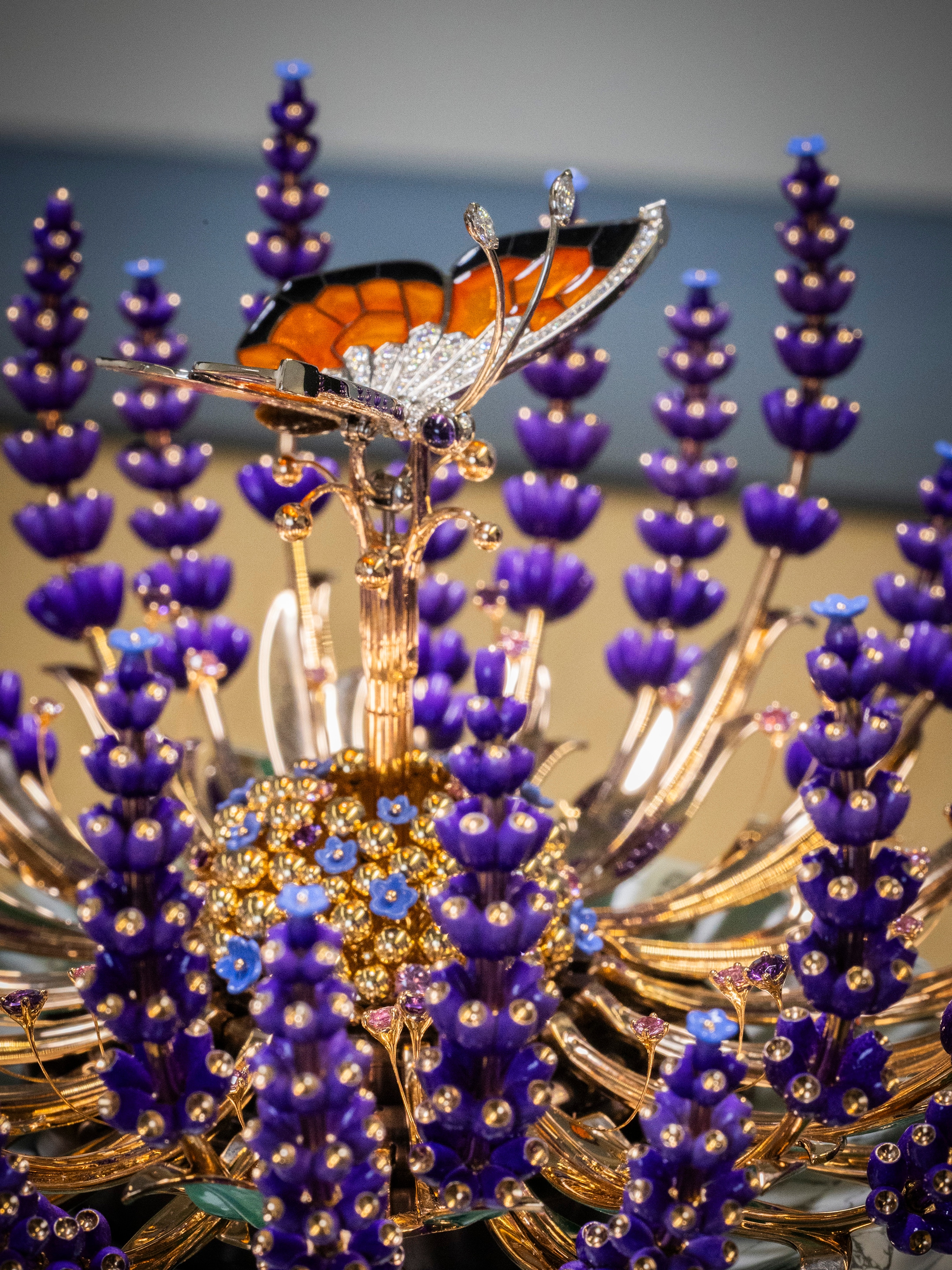 Brassée de lavande automaton. Rose, yellow and white gold, pink sapphires, amethysts, tiger's eye, verdite, howlite, diamonds, enamel, lacquer, ebony, leather, aluminium, steel. Automaton and mechanical movements, 12-hour/minute function on a 360-degree rotating ring, 8-day power reserve, on-demand animation with a melody, carillon of 5 bells and hammers. Extraordinary Objects™ collection, Van Cleef & Arpels.