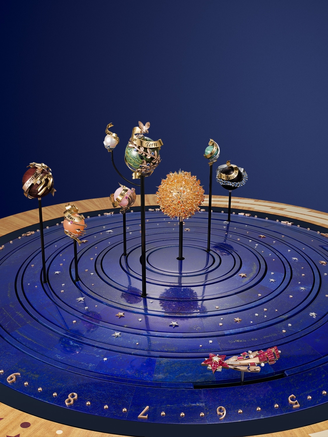 Planétarium automaton, yellow, white and rose gold, Traditional Mystery Set™ rubies, rubies, colored sapphires, spessartite garnets, diamonds, lapis lazuli, calcedony, pearl, jasper, jet, milky rose quartz, orange moonstone, lemon tree, ziricote, amaranth, white holly, glass, aluminium, steel, brass, PVD, leather. Automaton and mechanical movements, planetarium module, perpetual calendar, hour/minute dial, on-demand animation and carillon. Extraordinary Objects™ collection, Van Cleef & Arpels.