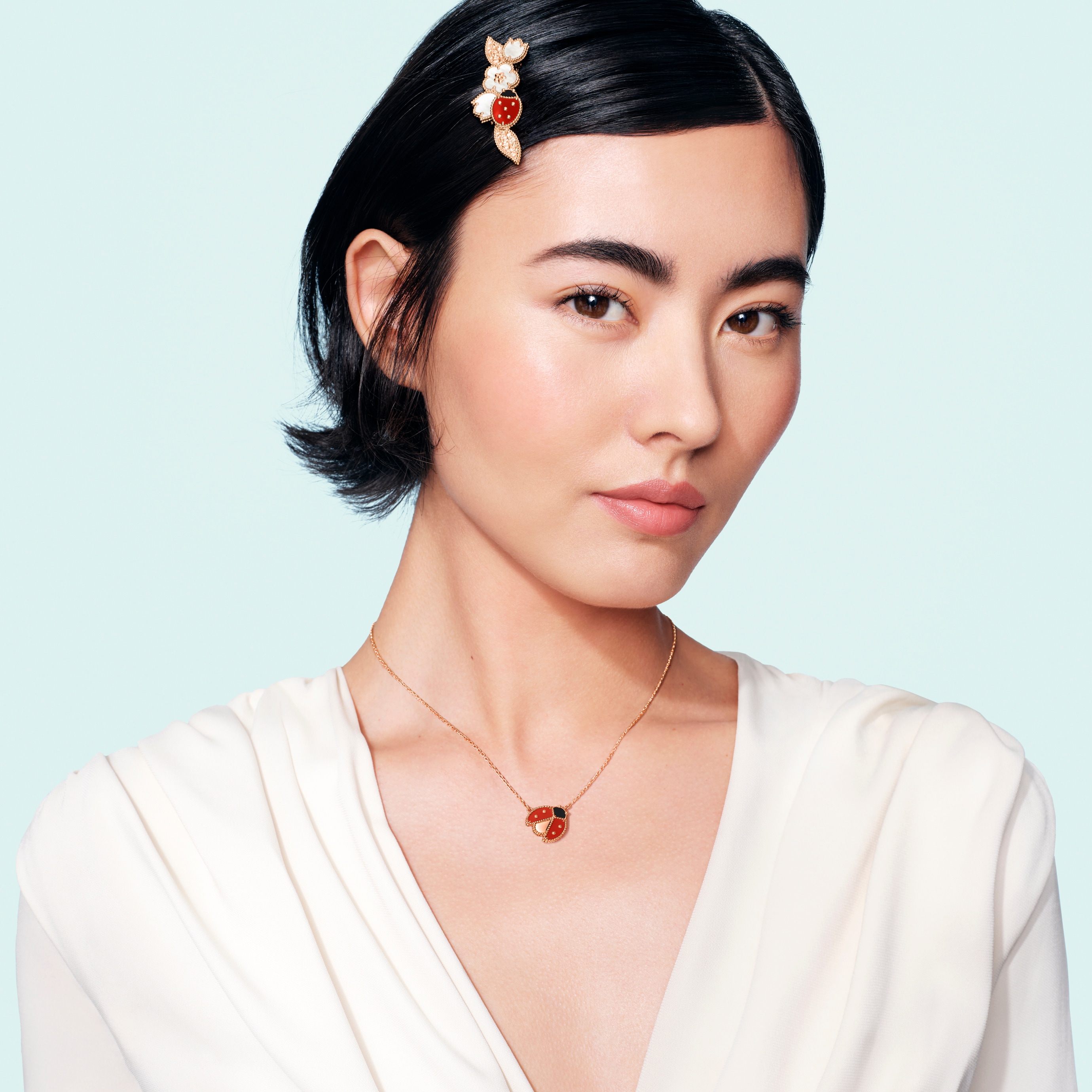 Lucky Spring pendant, open wings ladybug, 18K rose gold, carnelian, onyx and clip, 18K rose gold, white mother-of-pearl, carnelian, onyx. Lucky Spring collection, Van Cleef & Arpels.