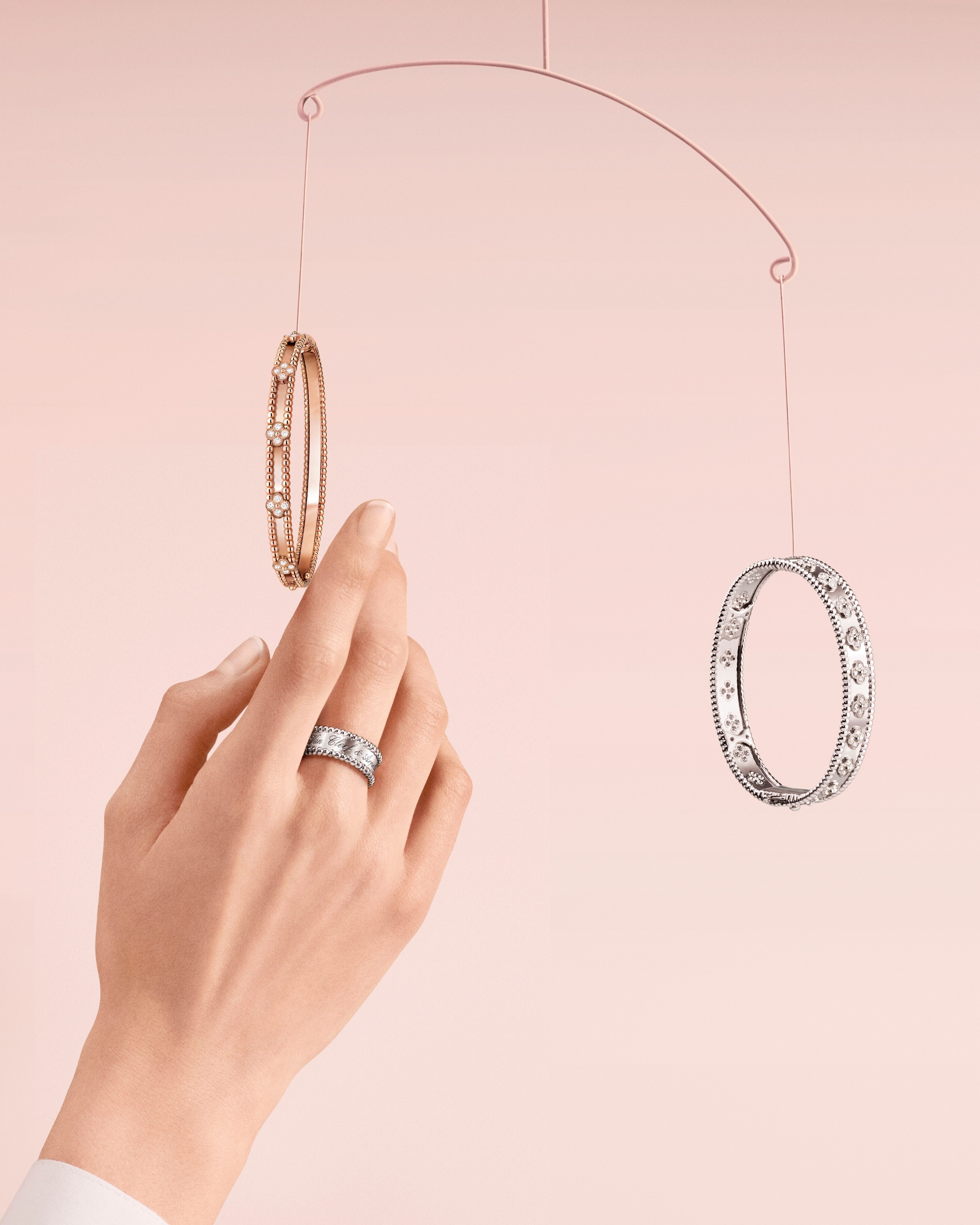 Perlée sweet clovers and Perlée clovers bracelets, 18K rose gold, 18K white gold, diamonds. Perlée signature ring, 18K white gold. Perlée® collection, Van Cleef & Arpels.