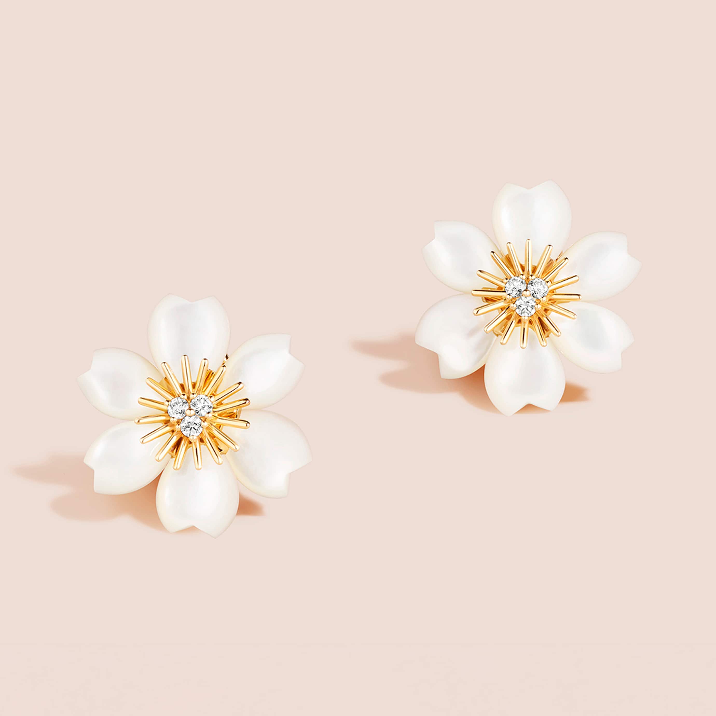 Rose de Noël earrings, mini model, 18K yellow gold, white mother-of-pearl, diamonds. Rose de Noël collection, Van Cleef & Arpels.
